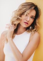 Obraz premium Portrait of beautiful young woman with makeup in fashion white clothes