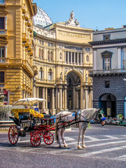 Naklejka premium NAPLES, ITALY - AUGUST 17, 2011: Horse carriage in front of the Galleria Umberto I.