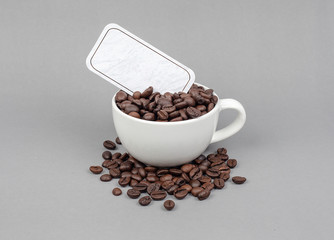 Premium coffee beans with name tags on a gray background.