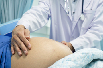 doctor examining pregnant patient