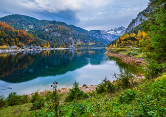 Fototapeta na wymiar Gosauseen or Vorderer Gosausee lake, Upper Austria. Autumn Alps mountain lake with clear transparent water and reflections.