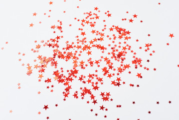 Abstract background with red confetti in shape of star on a white background