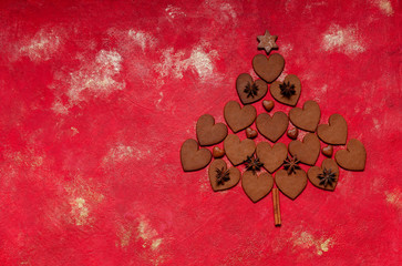 Original Christmas tree made from Homemade Heart Shape Gingerbreads on Red Lush Lava background. Top view, close-up. Christmas, New Year concept.