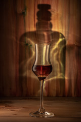 Glass of whiskey on the background of the bottle