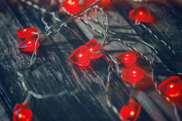 red heart lights on the wooden background