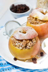 healthy breakfast. oatmeal with raisins baked in sweet apple, vertical top view