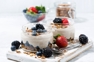 healthy creamy dessert with fresh berries on white background - obrazy, fototapety, plakaty