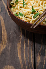 traditional Chinese noodles and chopsticks and wooden background, top view