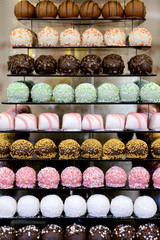 Tower or pyramid and cupcakes on sweet dessert table. Sweets in various stylish bonbons for sale