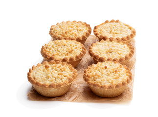 Mini apple and pear custard crumble tarts isolated on white