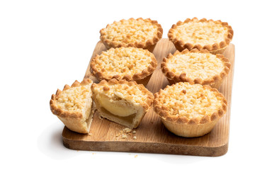Mini apple and pear custard crumble tarts isolated on white