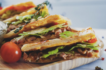 Skepasti: greek gyros with meat, tzatziki sauce, vegetables, cheese on wooden plate