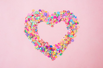 Different fimo slices on pink background. Copy space