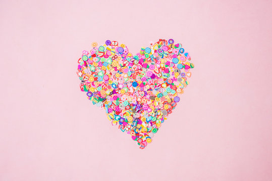 Different fimo slices on pink background. Copy space