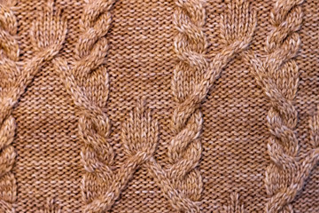 Fragment of brown knitted fabric. View from above.