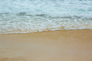 Fototapeta na wymiar white sea foam on yellow sand, sea background, sandy beach