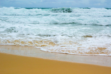 sea coast with rough seas, waves on a sandy beach, beautiful landscape in summer