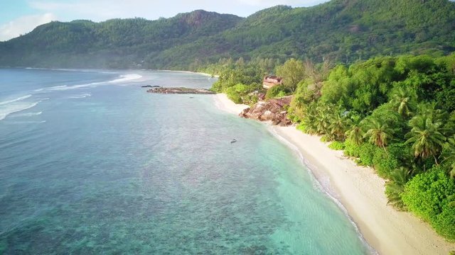 Beautiful beach with palm tree and rocks aerial top view drone shot at Seychelles, Mahe