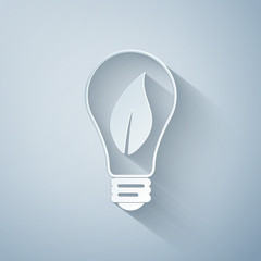 Paper cut Light bulb with leaf icon isolated on grey background. Eco energy concept. Paper art style. Vector Illustration