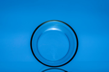 Glass cylinder on a glass table. Abstract still life.	