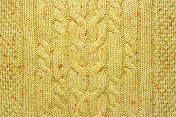 Texture of Wool Knit Color of Mustard Fabric Interspersed with Red Orange Yarn. Sweater Background Close-Up View