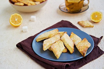 Homemade cottage cheese cookies in a clay plate on a light background concrete. Baking with cottage cheese.