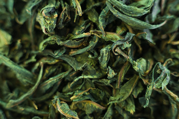 Close-up - collection of dried green tea leaves .Top view. Macro photo. - obrazy, fototapety, plakaty