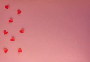 Hearts on a pink background. Valentin's Day, top view. Copy space. Flat lay. Greeting card.