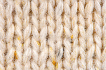 Texture of Wool Knit Beige Fabric Interspersed with Yellow Yarn. Sweater Background Close-Up View