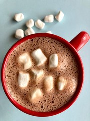 top view of a red mug with hot chocolate and marshmallows