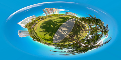 Tiny planet Miami Beach park scene palm trees and buildings