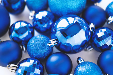 Classic blue New Year decoration. Abstract card on white background. Minimal flat lay and color of Year 2020 conceptconcept. Christmas balls composition. Winter holiday.