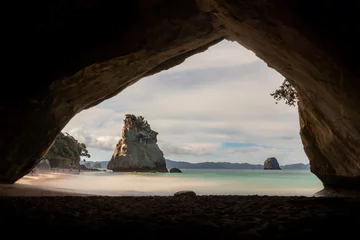 Foto op Canvas The famous view through the cathedral cave to the beach with the big rock in the back - Location: Coromandel, New Zealand - longexposure photography © Jimmy R