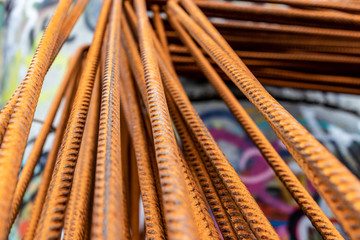 A group of rusty steel rods in an urban envirement