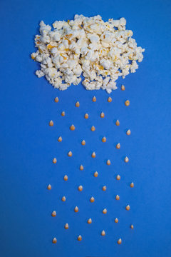 Concept with popcorn and corn - Corn rains from a popcorn cloud - Vertical image