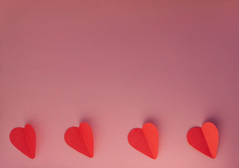 Hearts on a pink background. Valentin's Day, top view. Copy space. Flat lay. Greeting card.