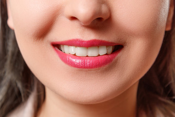 Fototapeta premium the smile of a young woman with perfect white teeth close-up