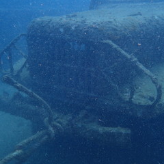 Military​ battle truck at the Shipwreck scuba diving site waves on a surface of water