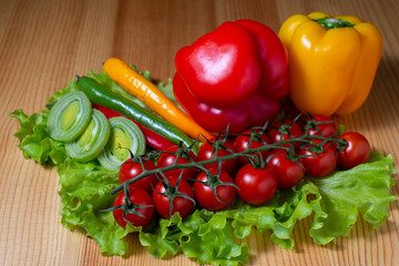 chili peppers, leek, paprika and cherry tomatoes on lettuce