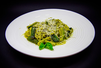 Zucchini paste and pesto sauce on black background