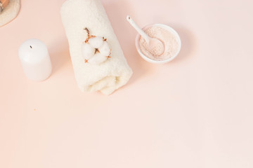 Spa beauty skin care minimal concept creative  lay out composition made of clay and rose cleansing mask cotton flower soft towel pink background with copy space top view