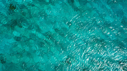 Aerial view of coast of Curaçao in the Caribbean Sea with turquoise water, cliff, beach and beautiful coral reef around St.Martha Bay