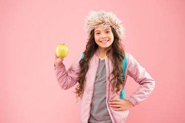 Lunch time. Winter semester. Teen with backpack. Healthy snack. Modern education. Stylish schoolgirl. Girl little smiling schoolgirl hold apple fruit. Schoolgirl happy daily life. Eating natural food