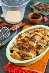Uncooked leftovers bread pudding with ingredients on a table