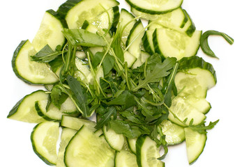 Obraz premium Vegetable salad on white background. Arugula cucumbers on a white background.