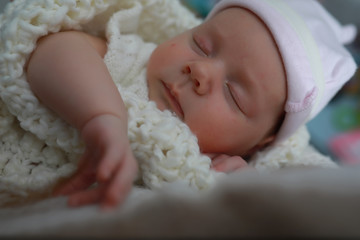 Baby newborn sleeping wrapped up in a blanket