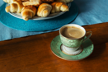 Cup of coffee with croissants plate