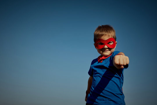 Super Hero Child (boy) Against Blue Sky