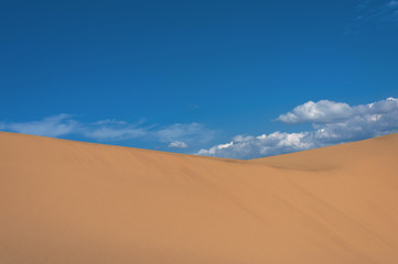 Fototapeta na wymiar Landscape with sand dune slope and cloudy sky