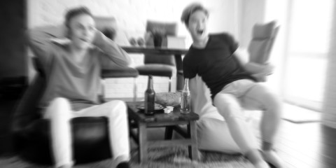 background football fans watch the match and drink beer